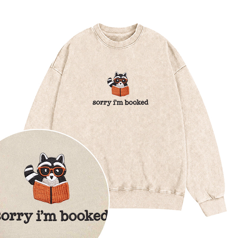 Embroidered Sorry I'm Booked Reading Raccoon Washed Crewneck Sweatshirt