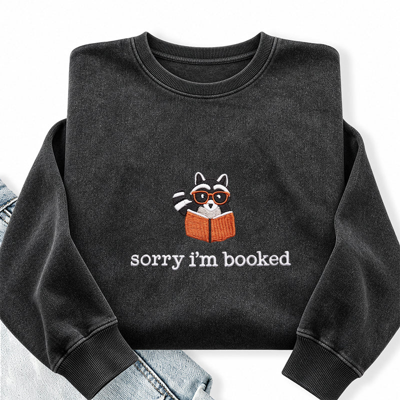 Embroidered Sorry I'm Booked Reading Raccoon Washed Crewneck Sweatshirt