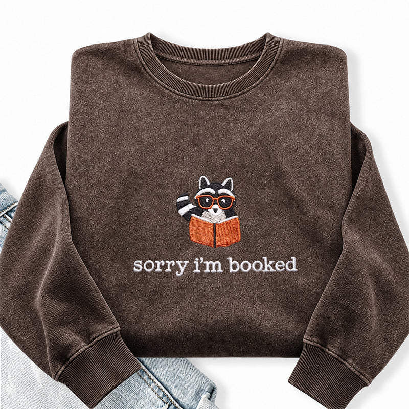 Embroidered Sorry I'm Booked Reading Raccoon Washed Crewneck Sweatshirt