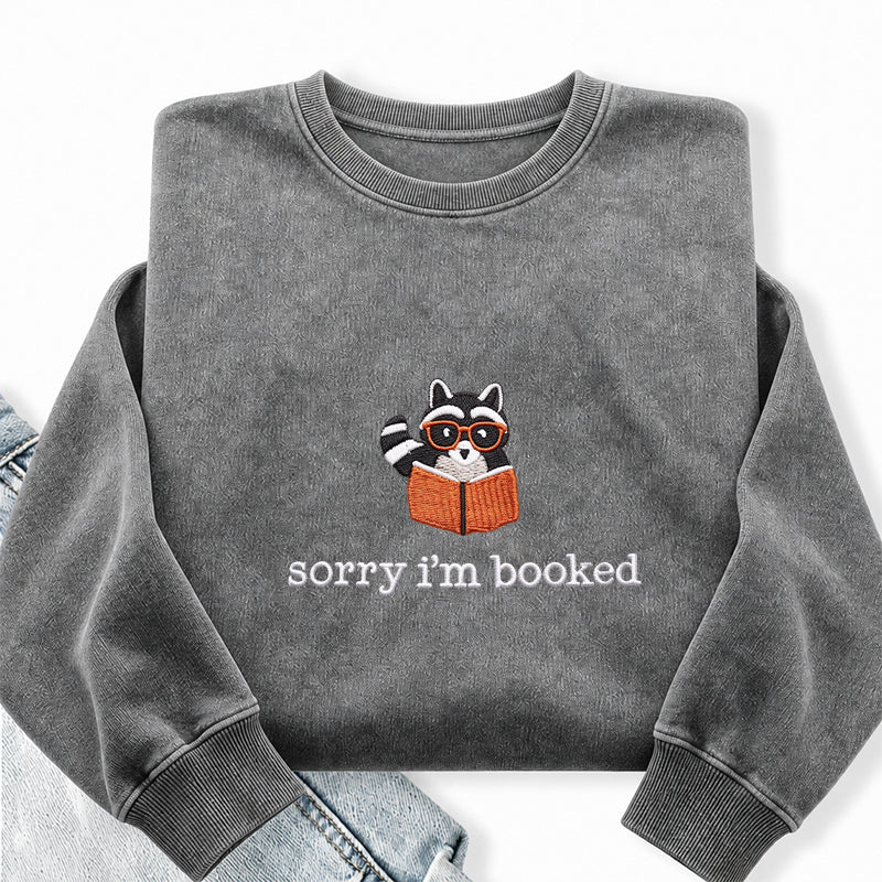 Embroidered Sorry I'm Booked Reading Raccoon Washed Crewneck Sweatshirt