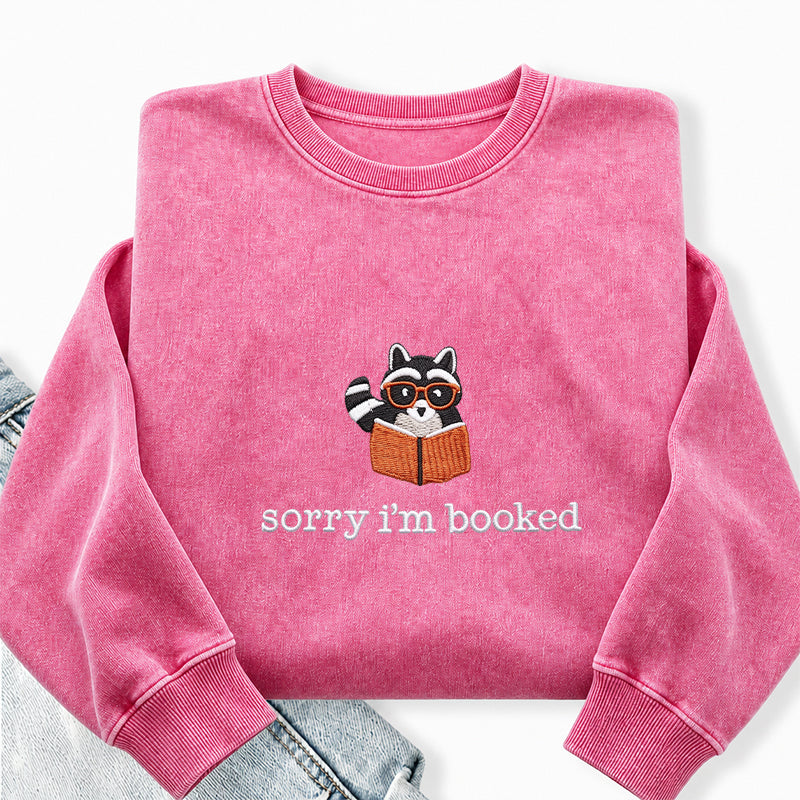 Embroidered Sorry I'm Booked Reading Raccoon Washed Crewneck Sweatshirt
